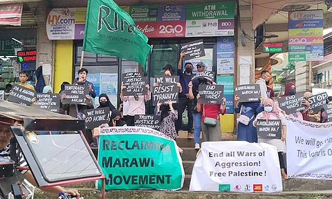 Internally displaced persons (IDPs) gather at the Kristal/Omairah Market in Marawi City on July 22, 2024, for the State of Marawi Bakwit Address (Sombak) 2024 to call for a safe and dignified return to their homes, seven years after the siege. With placards and emotional testimonies, the bakwits demanded truth, justice, and accountability from concerned agencies responsible for the distribution of compensation. While right photo shows Ramadan Muntor, coordinator of RMM, leading the movement.