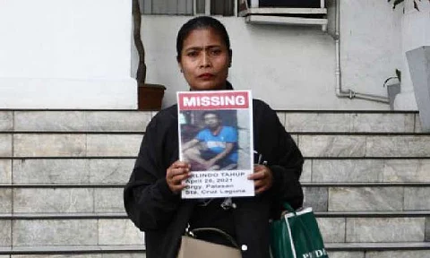MISSING. A family member shows a picture of her relative, who is among the scores of missing sabungeros (cockfight afficionados), before a meeting with Department of Justice officials on Friday (July 5, 2025). Justice Secretary Jesus Crispin Remulla assured the families of the missing men that the DOJ is exerting all efforts to solve the case. (PNA photo by Ben Pulta)