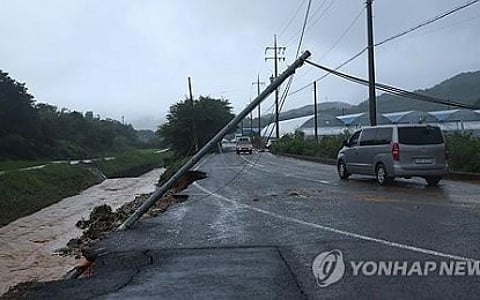 TOPPLED. A telephone pole leans above a road in the southern county of Sancheong on July 19, 2025, after heavy rains struck the area. At least 10 people killed while nine others remain missing because of the rains and landslide. (Yonhap)