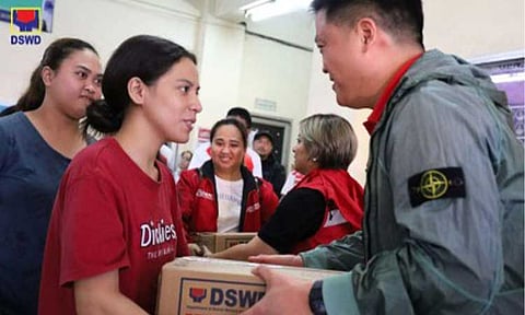 ASSISTANCE. Department of Social Welfare and Development (DSWD) Secretary Rex Gatchalian leads the distribution of food packs to families affected by heavy monsoon rains in Valenzuela City on July 22, 2025. The Department of Budget and Management said Friday (July 25, 2025) it has released PHP1.625 billion to replenish the Quick Response Funds of the DSWD and the Department of Public Works and Highways. (Photo from DSWD)