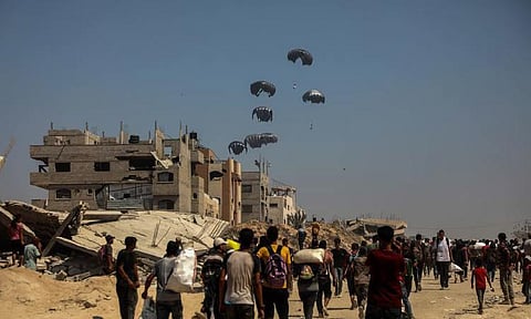 AID. People wait for the humanitarian aid dropped by an airplane in Gaza City, July 27, 2025. The Israeli military on Sunday announced a daily 10-hour humanitarian pause in its operations in parts of the Gaza Strip, along with the opening of secure routes for aid delivery, amid growing international pressure over the deepening hunger crisis there.