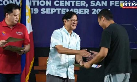 AID DISTRIBUTION. President Ferdinand R. Marcos Jr. leads the distribution of the financial assistance to farm workers and land titles at the Bren Z. Guiao Convention Center in San Fernando City, Pampanga on Friday (Sept. 19, 2025). The event aims to promote tenure security by granting land ownership rights to qualified beneficiaries in residential and agricultural areas. (Screenshot from Radio Television Malacañang)