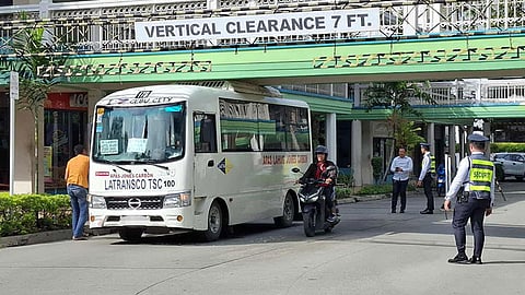 Modern jeep stuck under footbridge