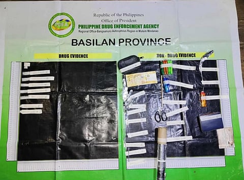 ZAMBOANGA. Lawmen arrest and drug suspect in an anti-drug operation on Thursday, October 9, in Malo-ong Canal village, Lamitan City, Basilan province. Two cohorts of the arrested suspects managed to escape during the buy-bust operation.