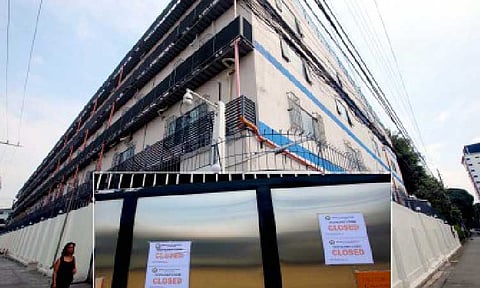 CLOSED. The Pasay City local government places “closed” signs at a six-story building in Pasay City on Nov. 2, 2023 following reports of online scams and sex trafficking, among other illegal activities. President Ferdinand R. Marcos Jr. has signed Republic Act 12312, institutionalizing the ban on Philippine offshore gaming operators and declaring their operations and other related activities illegal. (PNA photos by Avito Dalan)