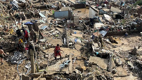 SEARCHING FOR WHAT REMAINS. Residents sift through debris to salvage what remains after floods swept away homes in Sitio Isla Verde, Barangay San Isidro, Talisay City, following typhoon Tino. Many lost nearly everything as muddy waters submerged the commuting sitting beside the Mananga River at the height of the storm early Tuesday, Nov. 4, 2025. /