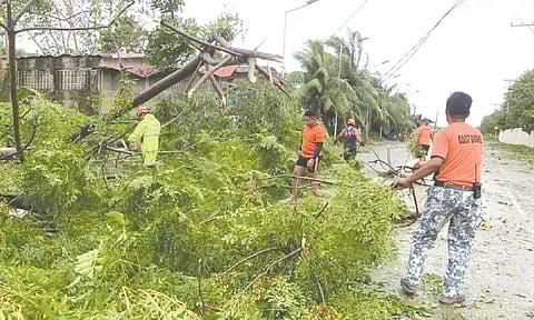 AFTERMATH. Members of the Philippine Coast Guard clear toppled trees and debris following typhoon Tino, which caused widespread power outages across Cebu. The Cebu Electricity Rights Advocates has urged power utilities to strengthen grid resilience and fast-track restoration efforts in affected areas. /