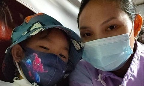 LTFRB-Davao Regional Director Nonito Llanos and other passengers covered the fare and assisted Ria Charmaine and her son Calix (in the photo), a leukemia patient, during the Undas rush. The viral story highlights compassion for House of Hope patients at SPMC.