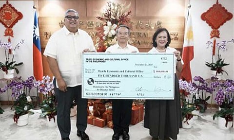 AID FOR TYPHOON VICTIMS. Taipei Economic and Cultural Office in the Philippines (TECO) Rep. Wallace Chow (center) handed over Taiwan's USD500,000 cash donation to support the Philippines' recovery efforts to Manila Economic and Cultural Office (MECO) Chairperson Corazon Padiernos in a ceremony in Makati City on Friday (Nov. 21, 2025). Atty. Joseph Castillo (left), MECO Board Member, witnessed the handover. (Photo courtesy of TECO)
