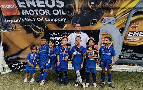 U6 CHAMPIONS. The Davao Strikers Football Club coach and players celebrate their undefeated run and Eneos Cup 2025 championship at Tionko Field on Sunday, November 23.