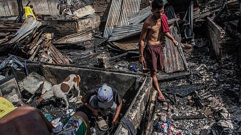 SEARCHING FOR THINGS. Residents in Sitio All Season 3, Barangay Cogon Pardo, Cebu City, searched for items that can still be of use on Wednesday morning, Dec. 10, 2025, a day after a nighttime fire hit their community.