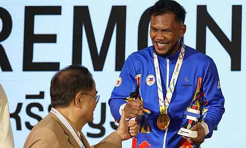 FIFTH SEA GAMES GOLD. Felix Marcial, who secured his fifth Southeast (SEA) Games for the Philippines in Thailand, beams as he is congratulated during the awarding ceremony after his championship fight against Indonesian Maikhel Muskita.