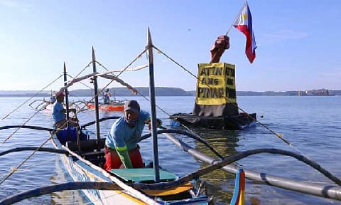LAWFUL DUTY. A group of fisherfolk releases an 18-foot symbolic buoy bearing the Philippine flag and a large “Atin ang Pinas” (The Philippines is Ours) sign off the waters of Barangay San Salvador, Masinloc, Zambales on Nov. 6, 2023. The Philippines on Monday (Jan. 12, 2026) rejected China’s claim that Manila is staging provocations in the West Philippine Sea, saying that protecting Filipino fishers within the country’s maritime zones is part of its lawful duty and not an act of escalation. (PNA file photo)