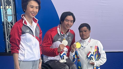 FILIPINO PRIDE. Davao City’s Ernie Gawilan, right, celebrates his gold medal won for the Philippines during the awarding ceremony of the 13th Asean Para Games 400-meter freestyle S7 event in Bangkok, Thailand