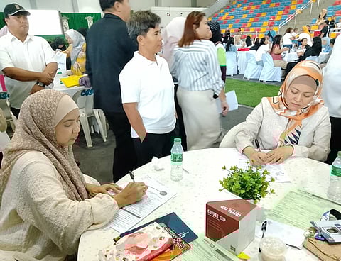 ZAMBOANGA. Mayor Sitti Djalia Turabin-Hataman of Isabela City, Basilan (seated, right) and Isabela City Information Officer Mendri Lim (seated, left) are among those who avail the products and services of Islamic Banks during the first-ever Islamic Banking Caravan on Tuesday, January 27.