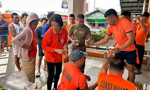 PCG SUPPORT. Personnel of the Philippine Coast Guard (PCGA) Auxiliary (PCGA) provide hot meals to stranded passengers at the Dumangas Port on Friday (Feb. 6, 2026). A total of 5,835 passengers were stranded in ports nationwide due to the effects of Tropical Depression Basyang. (Photo from Coast Guard Station Iloilo FB page)