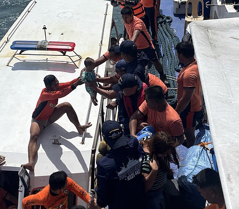 ZAMBOANGA. Philippine Coast Guard personnel transfer a child to BRP Tubbataha as they rescue 253 people, including 16 crewmen, from a vessel in distress on Friday, February 6, near Lampinigan Island, Isabela City, the capital of Basilan province.