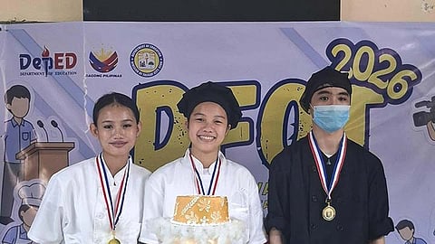 GOLD. John Fritz Lorence A. Guiao, a student with special needs, works well with the rest of the regular-stream teammates during the Bread and Pastry Production-Baking and Decoration contest. / Melody Jane R. Gabia, Junior Journo
