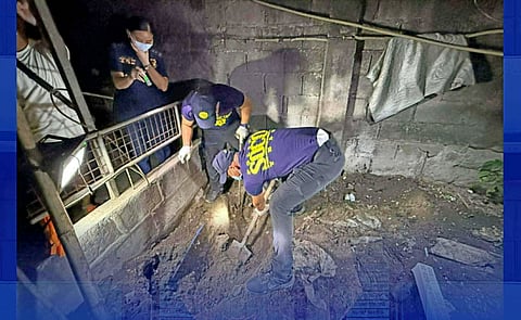 Members of the Scene of the Crime Operatives (SOCO) in Angeles City recover the body of Tess Mamac inside the family's residence compound on Monday, February 16. The victim was reported missing on February 12. ACPO photo