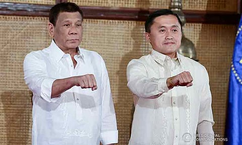 In this file photo, former President Rodrigo Duterte strikes his signature pose with Senator Christopher Lawrence “Bong” Go during the latter’s oath-taking ceremony at the Malacañan Palace on June 27, 2019.