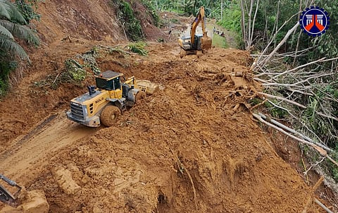 Personnel of DPWH this week continue to clear mud and other debris dumped by a landslide on a section of the national highway linking Lanuza and Cortes towns in Surigao del Sur.