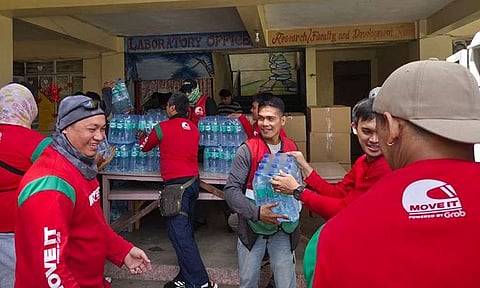 In photo, Move It rider-partners led a volunteer relief operation at Iligan City Central School, distributing hundreds of cases of drinking water and food packs to affected families.