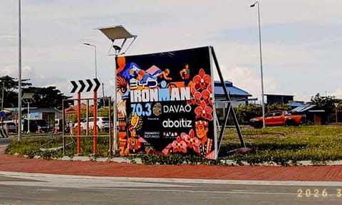 A tarpaulin promoting the upcoming IRONMAN 70.3 Davao is displayed at the rotonda along Roxas Coastal Road on Thursday, March 12, 2026, as the city prepares to host the international triathlon from March 20 to 22.