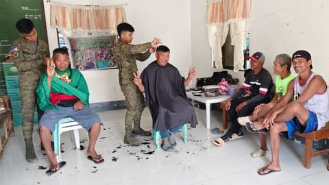 ILOILO. Soldiers of the 12th Infantry Battalion providing free haircut services during a community outreach program in Barangay Bayebaye, Jamindan, Capiz, as part of ongoing development and public service initiatives.