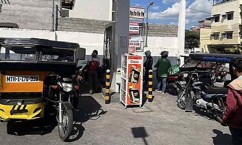 PUMP LINES. Motorists queue at a gasoline station along Palma Gil Street in Obrero, Davao City, on Tuesday, March 24, 2026, taking advantage of a fuel price rollback of ₱5 to ₱8 per liter. The station, bearing the tagline “Bayan ko, Mahal ko,” draws a steady stream of vehicles since early morning as drivers rush to fill up. As of 5 a.m., fuel prices were posted at ₱91.70 for diesel, ₱74.85 for unleaded, and ₱75.85 for premium gasoline. Stocks were later depleted.