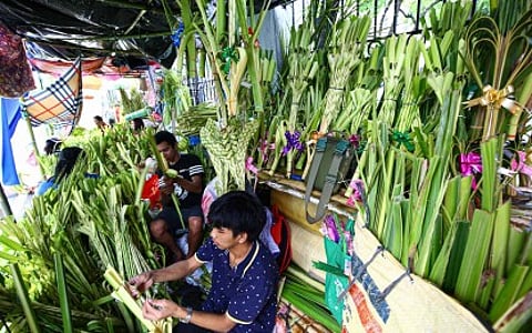 PALM ASSEMBLY. Vendors weave palaspas from fresh coconut and buri leaves outside Sto. Domingo Church in Quezon City on Saturday (March 28, 2026). President Ferdinand R. Marcos Jr. on Sunday (March 29) called on Filipinos to pause, reflect, and renew their faith as the country marks Palm Sunday and the start of Holy Week. (PNA photo by Joan Bondoc)