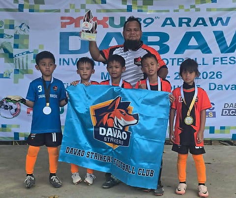 CHAMPIONS. Members of the Davao Strikers pose with their coach after winning the 7-Under title in the 89th Araw ng Davao Football Festival at Tionko Football Field in Davao City on March 29, 2026. The team capped an unbeaten run with a 3-1 victory in the finals. | Photo courtesy of Davao Strikers Football Club.
