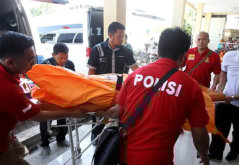 INDONESIA. Police officers carry a body bag containing one of the victims of Sunday's explosions upon arrival at a hospital in Surabaya, East Java, Indonesia, Monday, May 14, 2018. (AP)
