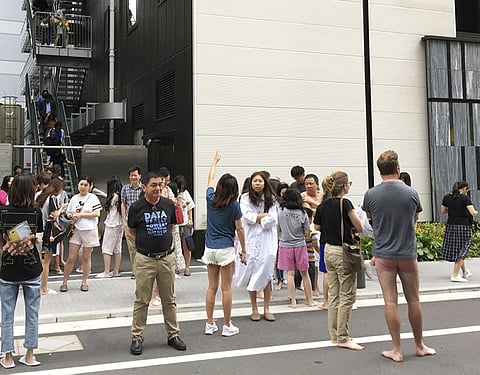 JAPAN. Guests take shelter outside a hotel in Osaka, following an earthquake Monday, June 18, 2018. (Kyodo News via AP)
