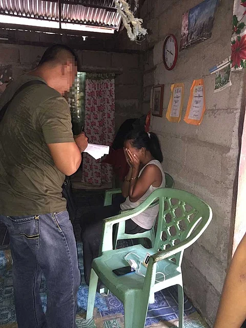 SAMAR. The suspect (covering her face) during the entrapment operation in Sta. Margarita, Samar. (Photo courtesy of International Justice Mission)