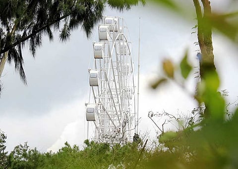 BAGUIO. A Ferris wheel towers the city as an added attraction to a mall. Baguio City Councilor Michael Lawana will spearhead a probe whether the establishment of an amusement park did not violate any city ordinance. (Photo by Jean Nicole Cortes)