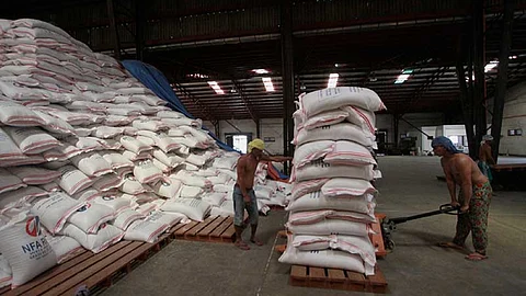 STACKED SACKS OF RICE. Workers unload sacks of rice in a National Food Authority warehouse on Gov. Cuenco Ave. Prince Warehouse Club.