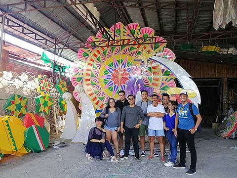 LANTERN TOUR. Manila bloggers pose together with master lantern maker Roland Quiambao at his lantern factory in Barangay Del Pilar. (Nicole Renee David)