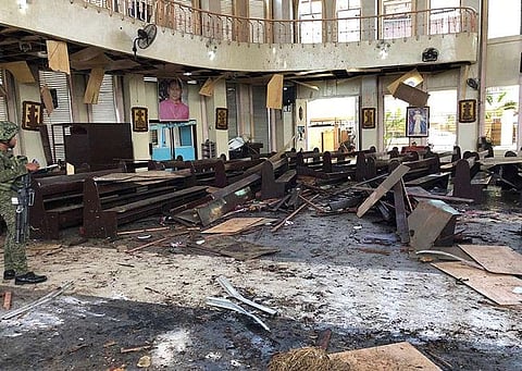 SULU. In this January 27, 2019, file photo provided by Wesmincom Armed Forces of the Philippines, a soldier views the site inside a Roman Catholic cathedral in Jolo, Sulu, after two bombs exploded. (AP)