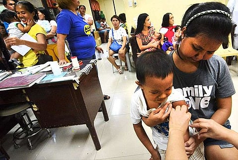 CEBU. Children receive the measles vaccine at the Barangay Guadalupe Health Center in Cebu City. Adults need the vaccine too, according to the Department of Health, which is providing free vaccination at its grounds in response to the measles outbreak in Central Visayas. (Amper Campana)
