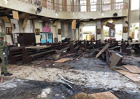 SULU. In this January 27, 2019, file photo provided by Wesmincom Armed Forces of the Philippines, a soldier views the site inside a Roman Catholic cathedral in Jolo, Sulu, after two bombs exploded. (AP)