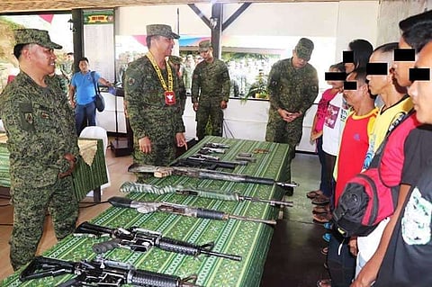 AGUSAN DEL SUR. Former rebels who belong to New People's Army surrender their firearms to the military. (Contributed photo)