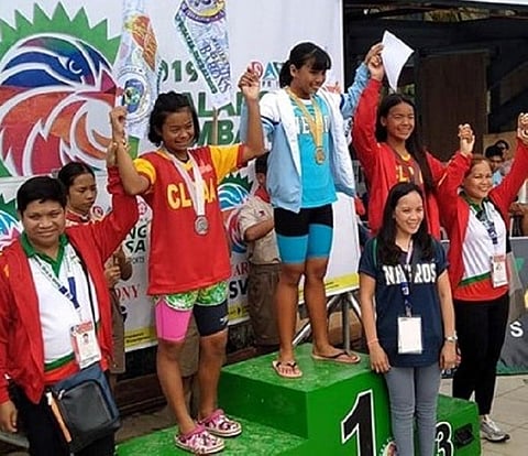 DAVAO. Alexie Kouzenye Cabayaran receives the gold medal in the Girls 12 & under 100 LC Meter Backstroke Elementary Girls with Central Luzon's bets as runners-up. (Photo by Maria Jenny Padronia Orcajada)