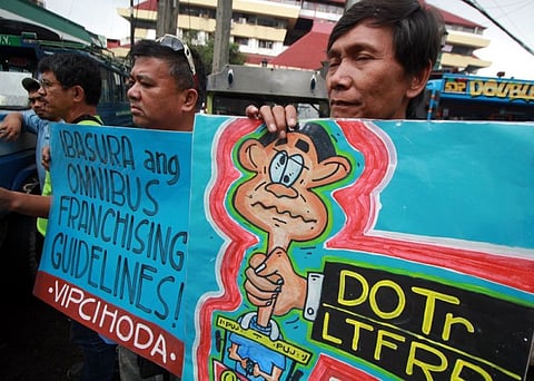 BAGUIO. Members of the Alliance of Jeepney Operators and Drivers in BLISTT express their sentiments against jeepney phaseout amid the downpour Wednesday morning, September 25, 2019. Members of the Pinagkaisang Samahan ng mga Tsuper at Draybers Nationwide (Piston) Metro-Baguio is set to join the nationwide mobilization against the planned Jeepney Modernization Program which they said is anti-poor and pro-capitalists. (Photo by Jean Nicole Cortes)