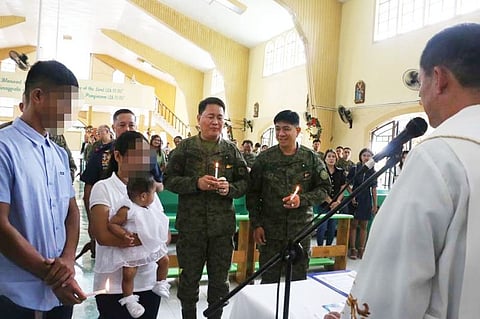 FORT MAGSAYSAY. Military and police officials led by (with candle from right) Northern Luzon Command Commander Lieutenant General Ramiro Manuel A. Rey, 7th Infantry Division Commander Major General Lenard T. Agustin and Police Regional Director Brigadier General Rhodel Sermonia serve as godfathers to the seven-month old child of former rebels.(Contributed by 7th Infantry Division)