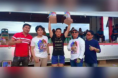 CAGAYAN DE ORO. Terrence Napat, 19, of M'lang, North Cotabato, steals the spotlight from the legendary Glenn Aguilar of Manila in the recent National Motocross Open in Tagoloan, Misamis Oriental. With him during the awards rites are Tagoloan Mayor Enan Sabio, Mohon village chair and event coordinator Jeyson Sabio and host barangay captain of Natumolan Rafael Vidal. (Lynde Salgados)