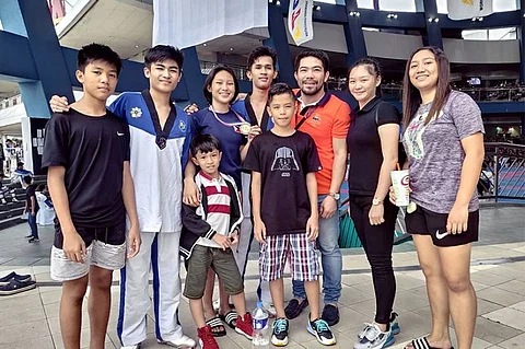 BACOLOD. Negros Occidental-Pride. (from left) Joshua Emmanuel Deita, Marcus Hinojas, Dondy Santillan, Mary Angeline Alcantara, Dex Ian Chavez, Ethan Chavez, Hanah Taekwondo gym coach Vic Feria, Ashley Chavez and Shaira Isabel Garbanzos during the just-concluded 2020 National CPJ Taekwondo Championships held at SM Mall of Asia. (Photo by Vic Feria)