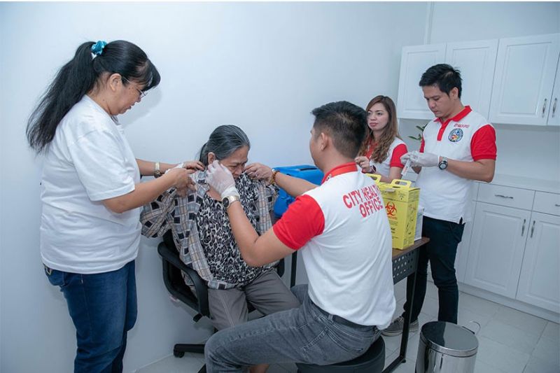ANGELES. City Health Office staff attend to an elderly during the opening of the Puso Center which aims to make Angeles the most caring city. (Contributed photo)