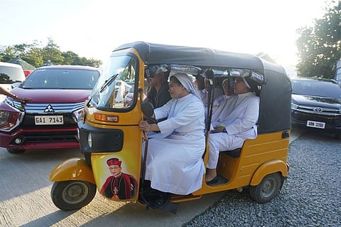 RIDING ON FAITH. Members of the Daughters of St. Teresa (DST) based in Carcar City ride on a tricycle with the image of their benefactor, the late Archbishop Teofilo Camomot. Catholics in Cebu celebrated Camomot's 106th birthday in Carcar City on Tuesday, March 3, 2020. Camomot, who died on Sept. 27, 1988, is being groomed for sainthood./ (SunStar Photo/ Alex Badayos)