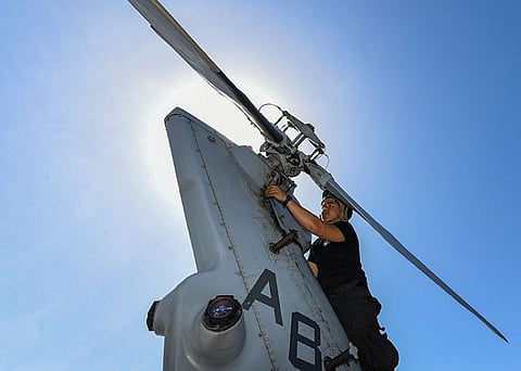 ARABIAN SEA. Aviation Machinist Mate 3rd Class Keith Gonzales, from Iloilo, Philippines, attaches tail gear box cowling to an MH-60R Sea Hawk helicopter, assigned to the "Proud Warriors" of Helicopter Maritime Strike Squadron (HSM) 72, on the flight deck of the guided-missile cruiser USS Normandy (CG 60). (US Navy photo by Mass Communication Specialist 2nd Class Michael H. Lehman)