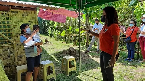 LEYTE. Barugo Mayor Macel Avestruz and other officials welcome the safe return of Myline and her son to their new home after their stay at the town's Covid-19 quarantine facility. (Photos courtesy of LGU-Barugo)
